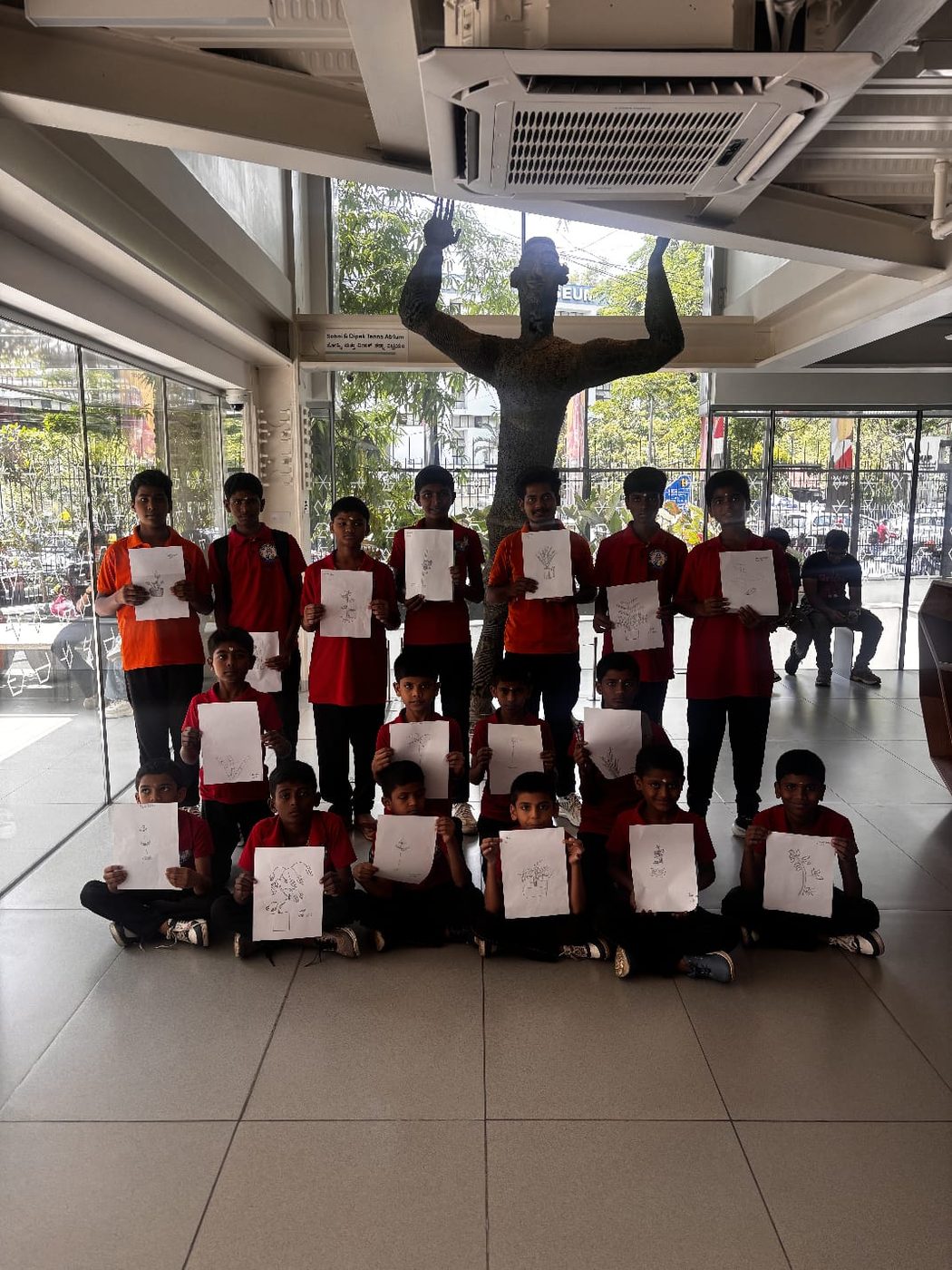 Children with their drawings at an art activity